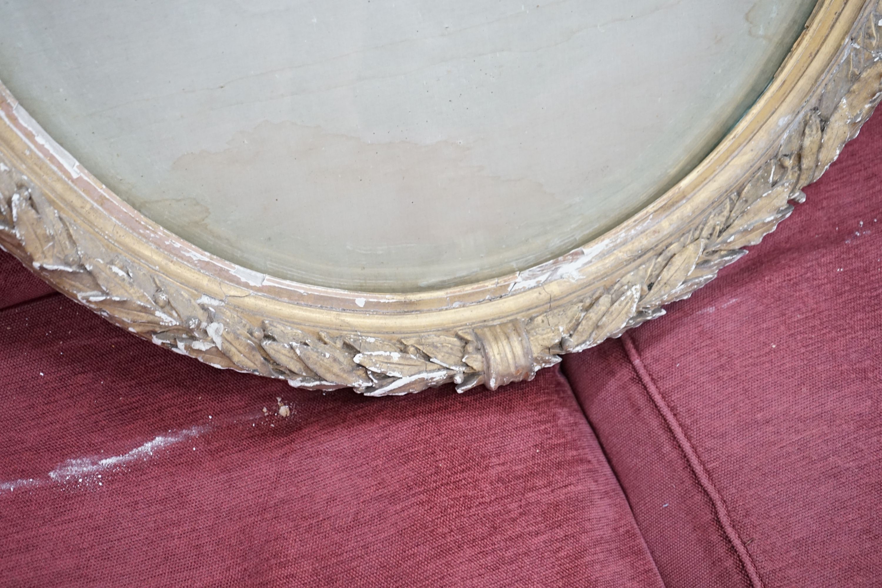 A Victorian oval gilt gesso display frame, width 66cm, height 80cm